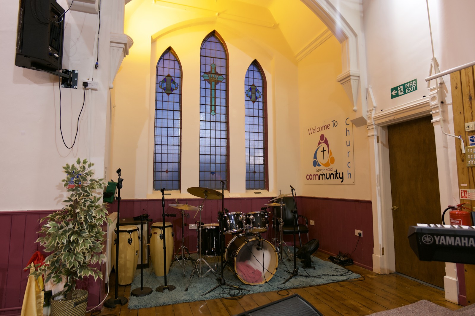 The worship band's corner beneath the stained-glass windows